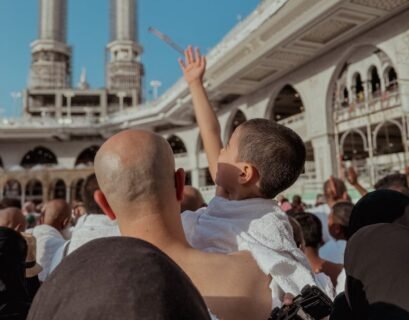 A Crowd Standing in the Courtyard of a Mosque