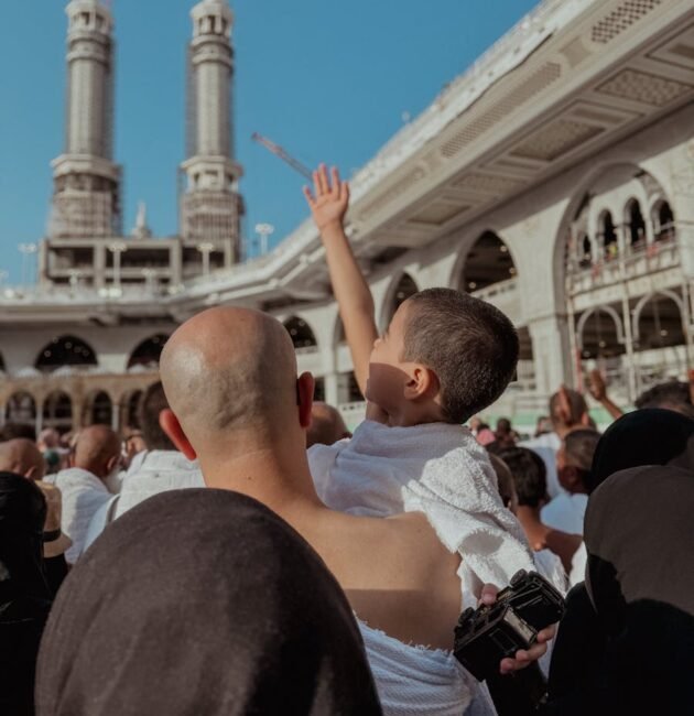 A Crowd Standing in the Courtyard of a Mosque