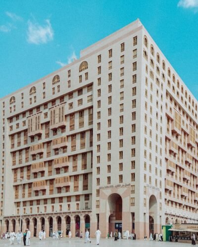 a group of people standing in front of a tall building