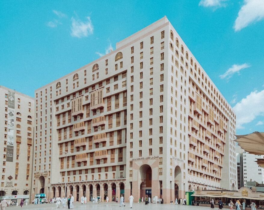 a group of people standing in front of a tall building